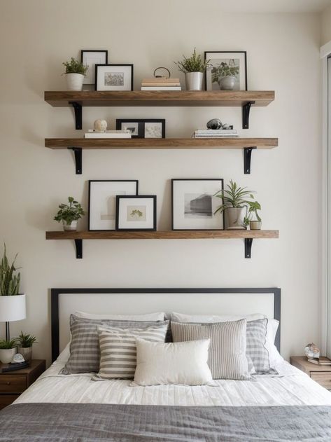 Create a modern and sleek look in your bedroom by arranging three floating shelves above your bed. Use them to display a combination of decorative items and functional storage, like books, plants, and small art pieces, for a stylish and organized space. Bedroom Shelf Decor Above Bed, Bedroom Shelving Ideas Above Bed, Floating Shelves Above Bed, Shelf Decor Above Bed, Small Bedroom Makeover Ideas, Creative Small Bedroom, Budget Bedroom Makeover, Small Bedroom Makeover, Shelf Above Bed