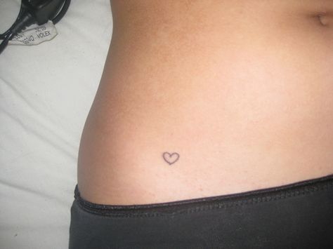 heart or peace sign tattoo Heart Tattoo On Waist Line, Minimal Waist Tattoo, Small Heart Tattoos On Hip, Pelvis Heart Tattoo, Heart Tattoo On Stomach, Tiny Heart Hip Tattoo, Tiny Heart Tattoo On Hip, Heart Tattoo On Hip Bone, Heart Tattoo Waist