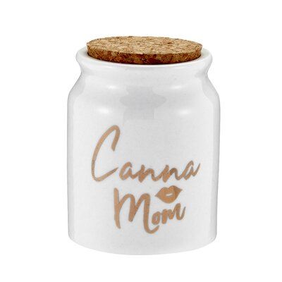 Ebern Designs Here is a great gift idea for a way-cool mom! A fun stash jar with a Canna Mom message will make her day. This stash jar is made of ceramic with a glossy white finish. It features the words 'Canna Mom' and a pair of lips in glitzy gold color. The stash jar is ideal to store teas, coffees, herbs, spices, and medical herbs. The tight-seal cork ensures that your herbs are kept fresh for months and that the sensitive material is protected from light. The jar comes packaged in an acetat Canna Mom, Medical Herbs, Stash Jar, Hemp Leaf, Herbs Spices, Stash Jars, Stash Box, Cork Lid, Kitchen Canisters