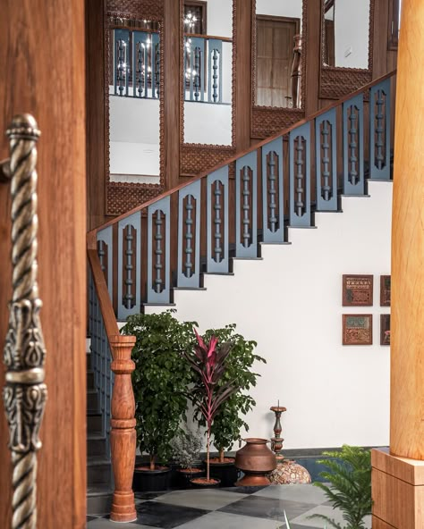 How beautifully balanced does the teak look with the steel blue? 😍 The carved wood trim lining the mirror and other intricate details create an impressive walk up to the upper level, showcasing a blend of timeless elegance and modern sophistication. Every element is thoughtfully designed to captivate and elevate the space. 😍  #studioipsa #interiordesignstudio #designisinthedetails #interiordesign #interiorstyling #homedecor #interiordesignideas #interiordesigninspiration #interiordesigninspo #interiorinspiration #interiordesigntrends Wood Handrail, Staircase Handrail, Hand Rail, Staircase Wall, Indian Interiors, Indian Home Design, Architecture Concept Diagram, Kerala Houses, The Staircase