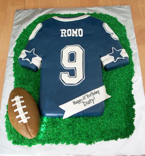 Football Jersey Cake - This is a Dallas Cowboys (Tony Romo) jersey cake for a 21st birthday.   It is a chocolate fudge cake covered in fondant with fondant and royal icing decorations, grass is buttercream and the football is made of crispy treats. Football Jersey Cake, Dallas Cowboys Birthday Cake, Dallas Cake, Dallas Cowboys Cake, Dallas Cowboys Birthday, Cowboy Birthday Cakes, Jersey Cake, Cowboy Cakes, Cowboys Jersey