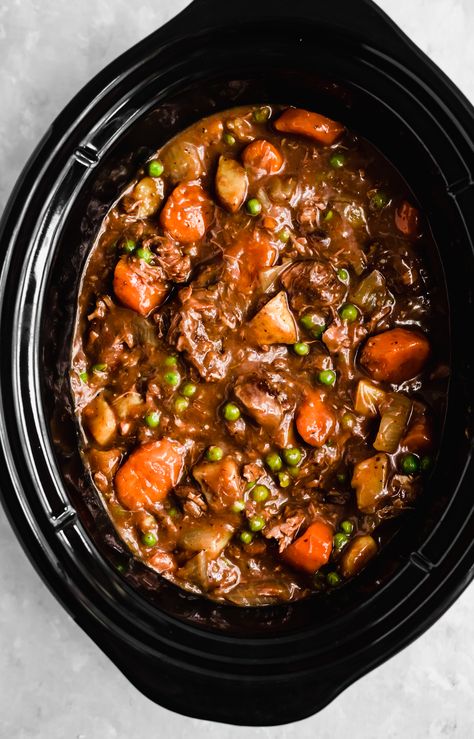 Mom's best ever slow cooker beef stew cooked to perfection with dry red wine, garlic, fresh herbs and tender potatoes and carrots. This easy beef stew recipe is just like the classic one you grew up with and makes a delicious, protein-packed dinner the whole family will love! #beefstew #slowcooker #slowcookerrecipe Stroganoff Crockpot, Slow Beef Stew, Stew Crockpot, Slow Cooker Recipes Beef Stew, Easy Beef Stew Recipe, Stew Beef, Stew Soup, Easy Beef Stew, Homemade Beef Stew