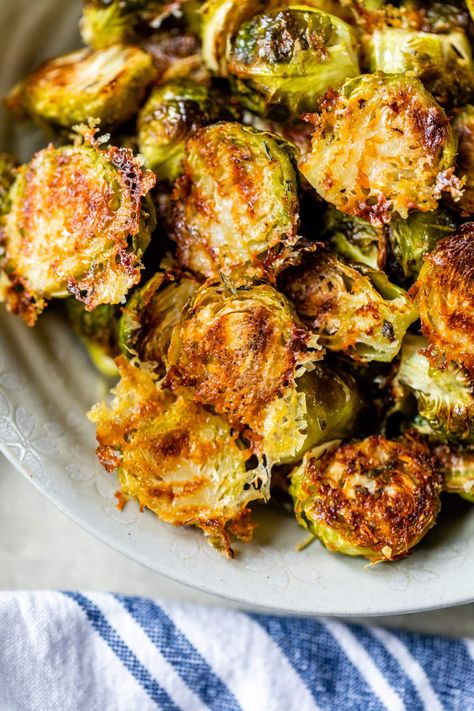 These crispy Parmesan Brussels Sprouts roast on a sheet pan with grated parmesan cheese and spices and are done in 30 minutes! #brusselssprouts #brusselsprout #sidedish #vegetablesidedish #healthyrecipes #weightwatcherrecipes