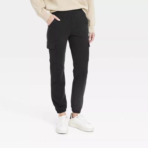 Tailored in a slim-fit silhouette, these mid-rise cargo jogger pants are crafted from a soft, midweight fabric with spandex for all-day stretchy comfort. Featuring a wide waistband that stays comfortable on your waist, these relaxed-fit joggers feature two side stash pockets and two side cargo pockets that you can use to hold small essentials. #travelpants #travelattire #affordabletravelpants #joggers #traveljoggers #travelwants #travelneeds #target Jogger Cargo Pants, Black Jogger Pants, Sweat Joggers, Travel Pants, Fitted Joggers, Cargo Joggers, Black Joggers, Hem Style, Wardrobe Ideas