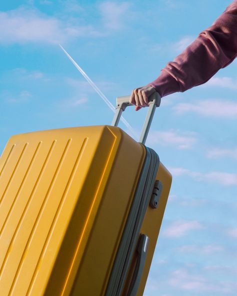 An unrecognizable person holds a travel yellow plastic suitcase by the handle against a blue sky Plastic Suitcase, Stay In The Moment, Viking Cruises, Luggage Brands, Suitcase Packing, The Tourist, American Tourister, Training Day, Suitcase Traveling