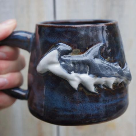 Hammerhead shark mugs are here ! I love how these turned out. These will be in my shop update on Saturday at 8pm, with or without handles #hammerheadshark #shark.ug #mugshot #ceramicmug #handmadeinwales Hammerhead Shark, Mug Shots, Ceramic Mug, I Shop, Handles, Mug, I Love, Quick Saves