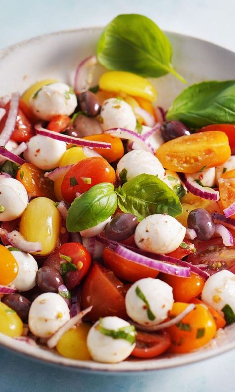 Tomato & Mozzarella Salad. This dish of marinated cherry tomatoes, olives, and mozzarella is super simple but oh so delicious, especially when cherry tomatoes are in season. Pearl Mozzarella And Tomato, Mozzarella Pearls And Cherry Tomatoes, Pearl Mozzarella Recipes, Tomato Basil Mozzarella Salad, Cherry Tomatoes Recipes Salad, Mozzarella Tomato Salad, Marinated Cherry Tomatoes, Tomato Basil Salad, Crouton Salad