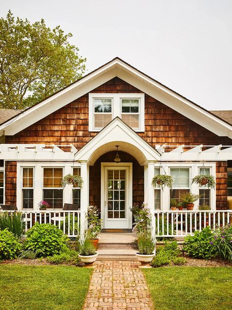 This shingle style home has curb appeal in spades! And inside? Its layered interior design packs in even more charm. Click the pin to take a full tour. Breezeway Sunroom, Porch Themes, Front Doors Colors, Doors Colors, Rustic Modern Cottage, Shingle House, Living Room And Kitchen Design, Shingle Style Homes, Paint Colors For House