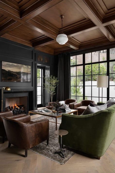 5 Ways To Create A Whole Home Paint Color Scheme. Modern living room with black walls and wood ceiling. Moody Media Room, Dark Moody Living Room, Hilltop Estate, Moody Interior Design, Mission Style Homes, Dark Accent Walls, Moody Living Room, Home Paint Color, Home Paint