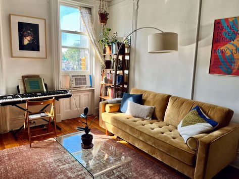 A sun-filled apartment with a mustard tufted couch, a keyboard, and a bookcase Mustard Couch, Girly House, Tufted Couch, Lots Of Plants, Brooklyn Apartment, Apartment Makeover, Rental Apartment, Apartment Art, Multipurpose Room