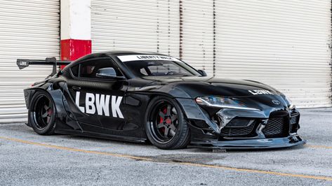 In addition to a lairy Liberty Walk kit, this Toyota Supra sits on a set of black wheels from Strasse Supra Mk4, Toyota Supra Mk4, Liberty Walk, Bmw Parts, Black Lips, Black Wheels, In Addition, White Stickers, Suspension Systems