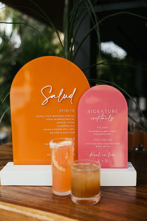 Pink and orange retro styled wedding signage beside cocktails Wedding Cocktail Ideas, Pallet Wedding Signs, Orange Wedding Themes, Orange And Pink Wedding, Signature Cocktails Wedding, Bar Signage, Pallet Wedding, Cocktail Hour Wedding, Cocktail Ideas