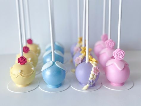 Another set of Princess Cake Pops 👑 this time I did Belle, Cinderella, Rapunzel & Aurora 💛🩵💜💖 #cakepops #princesscakepops #birthdaycakepops #princessbirthday #treatmaker Cinderella Cake Pops Ideas, Disney Princess Cake Pops Ideas, Disney Princess Cakepops, Princess Theme Desserts, Cake Pop Disney, Beauty And The Beast Cake Pops, Disney Princess Cake Pops, Princess Cakesicles, Cinderella Birthday Cake Ideas