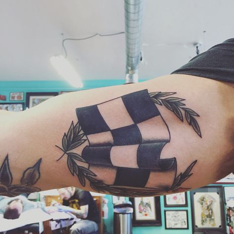 Recent traditional racing flag tattoo from Andy Canino @ Dedication Tattoo Racing Tattoos For Men, Racing Flag Tattoo, Racing Tattoos For Women, Race Car Tattoo, Checkered Flag Tattoo, Dedication Tattoos, Stripe Tattoo, Cover Up Tattoos For Men, Wreath Tattoo