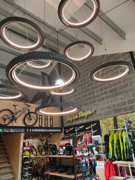 BESPOKE LIGHTS FIT FOR A NEW E BIKE SHOWROOM Motorcycle Showroom Interior, Motorcycle Showroom Design, Bike Showroom, Bicycle Room, Garage Furniture, Room Store, Cars Room, Wheel Chandelier, Motorcycle Shop