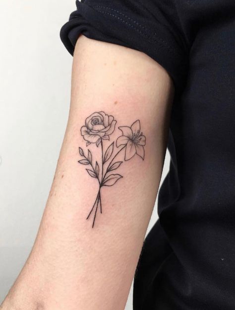 Two flowers intertwined as a tattoo done by @ellastormtattoo in London | www.otziapp.com Lilly Flower Tattoo, Honeysuckle Tattoo, Violet Flower Tattoos, Violet Tattoo, Carnation Tattoo, Lillies Tattoo, Lily Flower Tattoos, Daffodil Tattoo, Rose Flower Tattoos