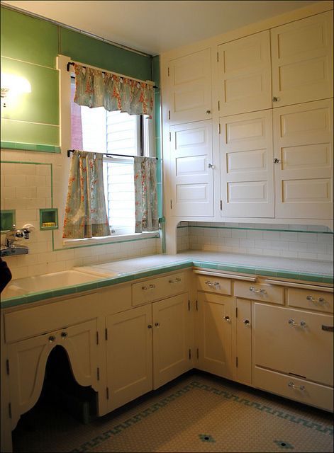 1930s Kitchen Intact Remodel. Here we go--finally--a kitchen that hasn't been re-muddled! I lvoe this original cabinetry! So beautiful and functional!!! Notes:cabinets don't match, wall mounted faucet, hoosier style cabinets to ceiling, toe-kick, glass knobs, sweet cut-out under sink, tile countertop, pull out boards. 30s Kitchen, 1930 Kitchen, 1930s Kitchen, Bungalow Kitchen, Kitchen Retro, 1930s House, Retro Renovation, Vanity Design, Kitchen Designs Layout