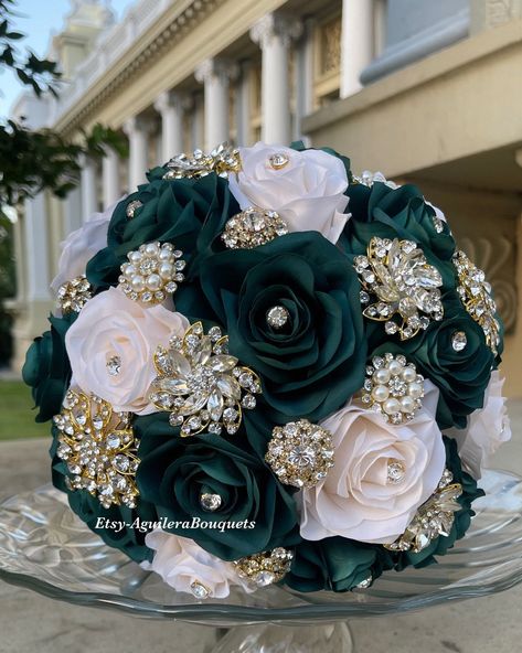 This bouquet is handmade with emerald green roses with beautiful gold brooches. The design can be change if requested. I can do it in different colors. Please message me the color. *This bouquet is 10 inches in diameter* Please contact me with any questions! :) Dark Green Quinceanera Suit, Emerald Green Quince Dress With Flowers, White And Emerald Green Bouquet, Emerald Green Quince Dress Tiara, Emerald Green Quinceanera Bouquet, Wedding Bouquets Bride Emerald Green, Emerald Quinceanera Theme Tiara, Dark Green Bridesmaid Bouquet, Quince Ramos Emerald Green