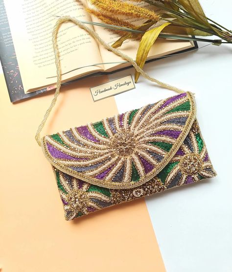 Handmade multicolor beaded clutch with intricate gold, green, and purple embroidery, featuring a detachable gold chain and magnetic closure. Perfect for Mardi Gras, weddings, evening parties, or formal events. A luxurious and vibrant accessory that makes a bold fashion statement, ideal as a gift for her or a standout piece for festive occasions Mardi Gras Fashion, Embroidery Clutch, Embroidered Clutch Bag, Bridal Party Accessories, Multicolor Embroidery, Embroidered Purse, Purse Luxury, Beaded Clutch Bag, Luxury Party