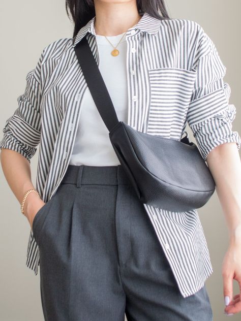 Close-up detailed outfit shot of Sharon of Her Simple Sole wearing a white tank top and grey wide leg pants with a striped button down shirt and a slouchy crossbody bag | minimalist outfit ideas | smart casual outfit Office Outfit Minimalist, Button Up Shirt Layering, Shirt With Pants Women, Minimalist Layering Outfit, Grey And White Striped Shirt Outfit, Minimalist Masc Outfit, Button Down Shirt Work Outfit, Gray Striped Shirt Outfit, Uniqlo Wide Leg Pants Outfit