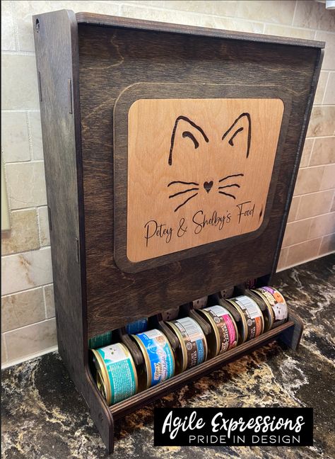 I could not find a suitable storage solution for my fur babies' canned food, so I made one! 😸 Custom pet food dispenser for 3oz or 5.1/5.5oz cans made from 1/4" birch, hand finished with stain and Odie's Oil to protect the pieces. Custom made for 3 oz. or 5.1/5.5 oz. canned food: 3 oz. size Fits 36 - 3 oz. cans: 15.25" x 6.25" x 11.50" 5.1/5.5 oz. size fits 30 - 5.5 oz. cans: 15.4" x 8" x 12.5" Please be sure to enter your desired text in the order notes box when checking out if choosing the "s Wet Cat Food Storage, Cat Food Container Ideas, Cat Food Can Storage, Canned Cat Food Storage Ideas, Cat Food Organization, Wood Dog Food Storage, Cat Food Station Dog Proof, Pet Storage Ideas, Pet Supply Storage