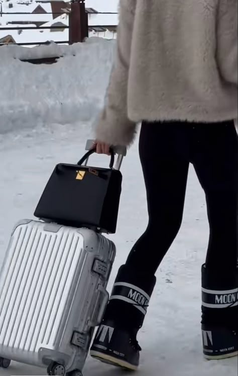 Silver Rimowa suitcase carryon, black kelly bag, luxury ski trip, snow, expensive christmas trip, black moon boots Ski Moon Boots, Black Moon Boots Outfit, Black Moon Boots, Christmas Suitcase, Moon Boots Black, Rimowa Suitcase, Aspen Trip, Moon Boots Outfit, Expensive Christmas