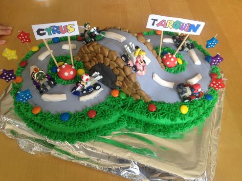 I am rather proud of this one.  The twins were turning four, and I convinced them that one cake to share was a good idea.  It was quite simple to achieve and I love the effect. I bought the little … Mario Kart Cake, Race Track Cake, Racing Cake, Mario Birthday Cake, Mario Bros Cake, Super Mario Cake, Super Mario Bros Birthday Party, 8th Birthday Cake, Mario Cake