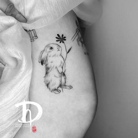 Dreamhands tattoo on Instagram: "Nancy did two cute bunnies. Keen to do more lovely pet tattoos. Online booking at www.dhtattoo.co.nz #finelinetattoo #finelinetattoo #pettattoos #smalltattoos #matchingtattoo #tattoolovers #aucklandtattoo" Bunny Holding Flower Tattoo, Bunny With Flowers Tattoo, Bunny Flower Tattoo, Baby Bunny Tattoo, Fine Line Bunny Tattoo, Cute Rabbit Tattoo, Peter Rabbit Tattoos, Ruby Tattoo, Lily Tattoos