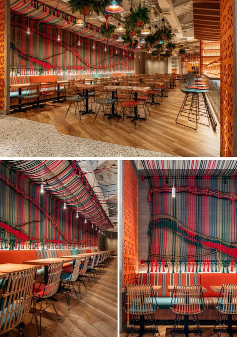 The mural, created by a local artist, wraps around from the ceiling and onto the wall, and is made from 137 pieces of rope that each measure in at 34 feet in length. Photography by Kris Tamburello Another interesting design feature in the restaurant, is the inclusion of a large wood communal table that’s surrounded by swinging chairs, adding to the playful, relaxed vibe of the space. Photography by Kris Tamburello Get the contemporist daily email newsletter – sign up here Mexican Restaurant Design, Mexican Restaurant Decor, Colorful Restaurant, Peruvian Restaurant, Restaurant Design Inspiration, Industrial Restaurant, Florida Restaurants, Modern Mexican, Restaurant Ideas