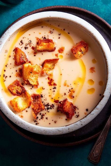 This garlic soup recipe is smooth and creamy, and a specialty at Bayona in New Orleans. What seems like a prodigious amount of garlic is mellowed by the long, slow cooking. Garlic Soup Recipe, Garlic Soup, Fall Soups, Soup And Stew, Soup And Sandwich, French Bread, Slow Cooking, Delicious Soup, Chicken Stock