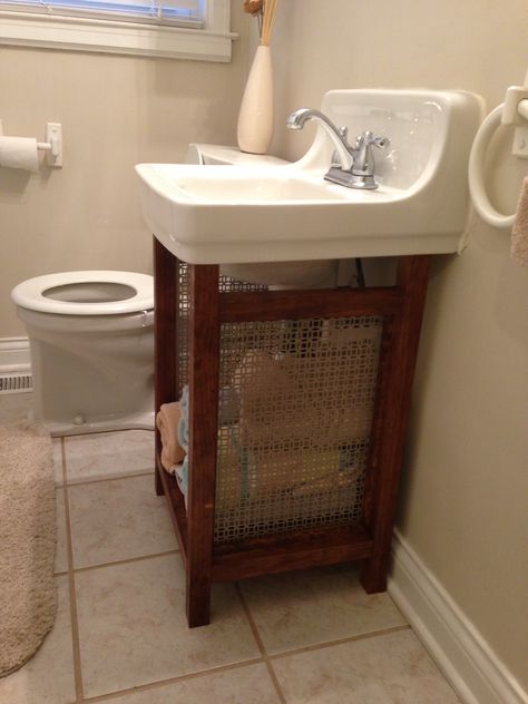 Solution for old wall mounted sink that is super hard to replace: pine boards and vent grate make a cute, open vanity with plenty of storage and hides the ugly old pipes. Under Bathroom Sinks, Under Bathroom Sink, Shabby Chic Bathrooms, Bathroom Sink Storage, Sink Cover, Wall Mounted Sink, Shabby Chic Bathroom, Sink Storage, Tv Bracket