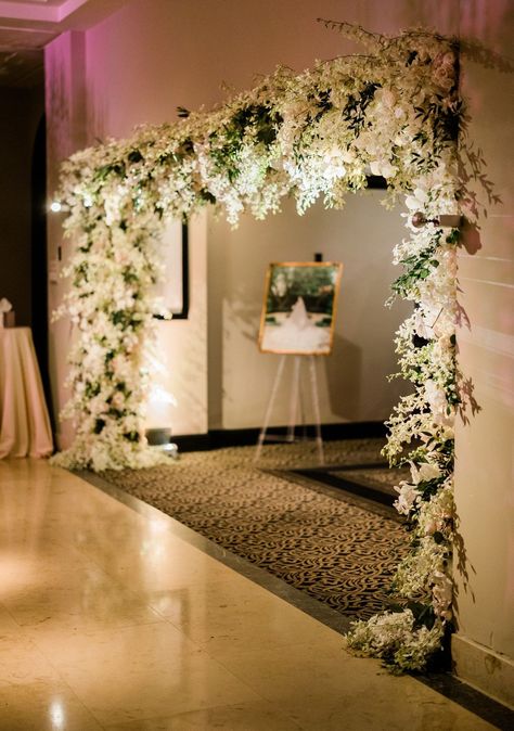 This stunning floral wedding reception entrance with white flowers and greenery wowed guests as they entered the ballroom. To see more of this elegant Houston wedding head to the blog! Ballroom Entrance Decor, Elegant Wedding Entrance Decor, Lobby Decor Wedding, White And Green Decor Wedding, White And Green Wedding Entrance, Flower Wedding Entrance, Green Wedding Entrance, Wedding Hall Entrance Decorations, Reception Entry Ideas