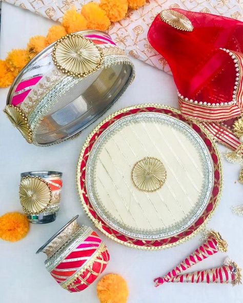 Elegant a d beautiful karwachaut set in gota Set consists of - 1 Thaali - 11 inch 1 Lota 1 Channi 1 Glass 2 cones 1 Thaal covers DM us for more details or WhatsApp us on 9867422790 Karwa Chauth Thali, Thali Decoration, Thali Decoration Ideas, Decoration Ideas, Glass, Quick Saves