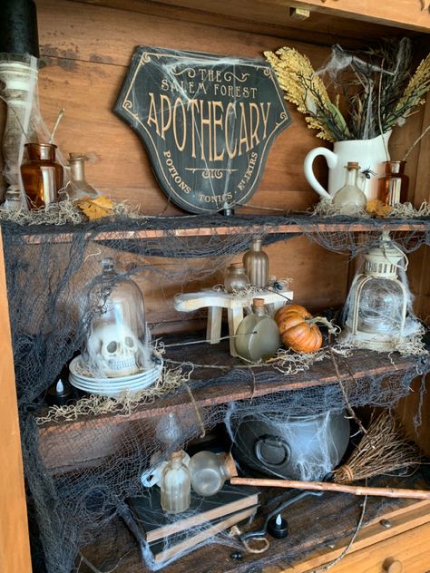 Halloween Decorations Apothecary, Halloween Witch Apothecary, Apothecary Cabinet Halloween, Spooky Apothecary Display, Halloween Decor Apothecary, Halloween Apothecary Display Diy, Halloween Hutch Display, Kitchen Window Halloween Decor, Halloween Curio Cabinet