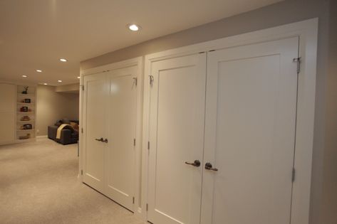 Basement Storage With Doors, Hidden Basement Storage Ideas, Wall Of Closets Basement, Basement Cabinets Storage, Basement Remodel Small Spaces, Hidden Basement Storage, Basement Closet Storage, Basement Closet Ideas, Storage In Basement