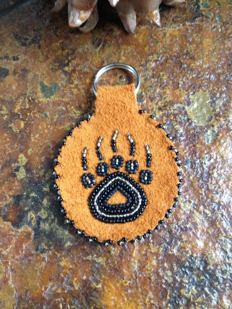 A personal favorite from my Etsy shop https://www.etsy.com/listing/289489443/bear-paw-print-key-chain Beading Medallions, Beaded Vamps, Bear Paw Beading Pattern, Bear Paw Beadwork, Beaded Keychains Native American Pattern, Métis Beading, Beaded Turtle Native American, Alaskan Native Beadwork, Beaded Keychains Patterns