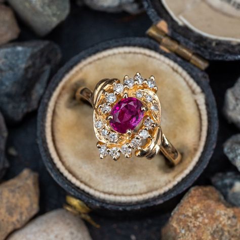 This beautiful ring is centered with one (1) oval mixed cut natural ruby set into a four- prong setting. The ruby is bordered with twelve (12), prong set, round brilliant cut diamonds and six (6), bead set, round brilliant cut diamonds. The ring measures 14.6mm at the top, rises 7.2mm above the finger, tapering to 2.2mm wide and 0.9mm thick at the base of the shank. This ring is currently a size 6.25. Ruby And Emerald Ring, Unique Sapphire Rings, Ruby Diamond Engagement Ring, Most Beautiful Engagement Rings, Gem Rings, Ruby Wedding Rings, Ruby Set, Golden Rings, Ruby Diamond Ring