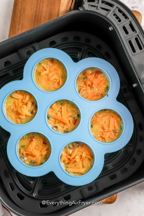 Air Fryer Egg Bites have been made popular by Starbucks and for good reason! These light and fluffy egg bites are made in the air fryer, and this homemade recipe tastes just as good as the restaurant version. Grab a silicone mold and some eggs or egg whites, and get cooking. Add bacon or ham, extra vegetables, or cheese for the best keto breakfast ever. #airfryereggbites #everythingairfryer #breakfastrecipes #airfryerbreakfast Silicone Egg Mold Recipes Air Fryer, Egg Bites Silicone Mold Microwave, Egg Bites Silicone Mold Air Fryer, Egg Bites In Silicone Mold, Air Fryer Silicone Mold Recipes, Starbucks Egg Bites Recipe Air Fryer, Air Fryer Egg Bake, Air Fryer Eggs In Silicone Cups, Egg Bites In Silicone Mold In Oven