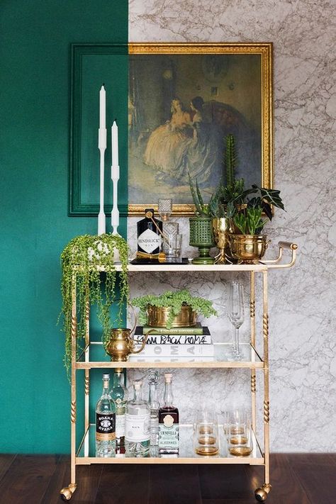 a chic and glam gold bar cart on casters, with potted greenery and succulents, with books and glasses plus a vintage artwork over the cart Bar Cart Ideas, Diy Bar Cart, Bar Trolley, Gold Bar Cart, Bar In Casa, Bar Cart Styling, Drinks Trolley, Cart Ideas, Cart Decor