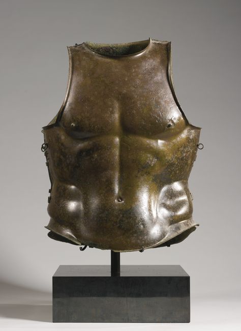 A GREEK BRONZE CUIRASS, CIRCA 4TH CENTURY B.C. composed of a front and back plate held together by hinges and by sets of twin attachment rings for leather straps, holes for now lost attachment rings on each shoulder strap, the muscles, spine, and navel clearly indicated, the nipples attached separately, the lower girth increasing to facilitate horseriding.  Height 21 in. 53.3 cm. Bronze Armor, Greek Armour, Greek Armor, Greek Artifacts, Ancient Greek Culture, Greek Hoplite, Roman Armor, Classical Greece, Ancient Armor