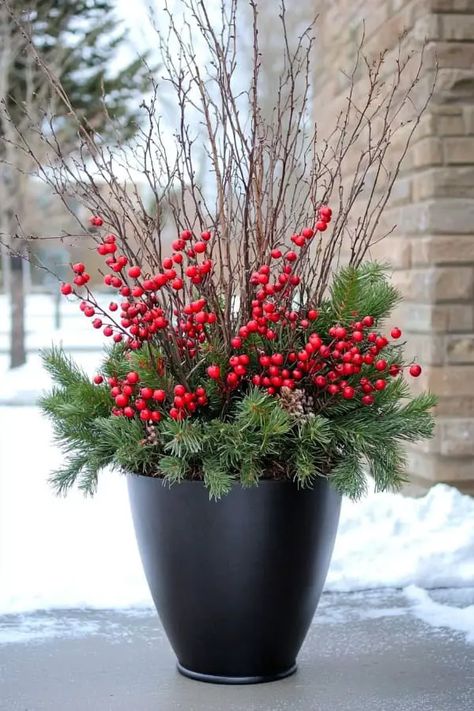 29 Winter Planter Ideas to Transform Your Outdoor Space This Season Winter Outside Pot Ideas, Winter Outside Planter Ideas, Christmas Outdoor Arrangements, Winter Flower Pots Front Porches, Holiday Planters Outdoor, Poinsettia Front Porch Decor, February Front Porch Decor, Small Porch Christmas Decorations, Decorating With Poinsettias