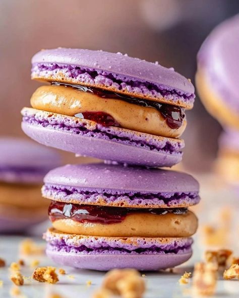 Purple and Brown Macarons with Peanut Butter & Jelly Filling 🍇🍪 These delightful macarons feature a purple and brown theme, filled with a creamy peanut butter frosting and a hint of grape jelly for a nostalgic PB&J flavor combo. Ingredients: Purple Macarons: 1 1/4 cups confectioners' powdered sugar (Imperial Sugar) 4 oz almond flour (by weight) 3 egg whites, room temperature Pinch of salt 1/4 cup extra fine granulated sugar (Imperial Sugar) 3-4 drops light purple gel food coloring Brown Maca... Brown Macarons, Purple Macarons, Macaron Fillings, Purple Ideas, Macaron Filling, Brown Theme, Macaron Flavors, Purple Food, Purple And Brown