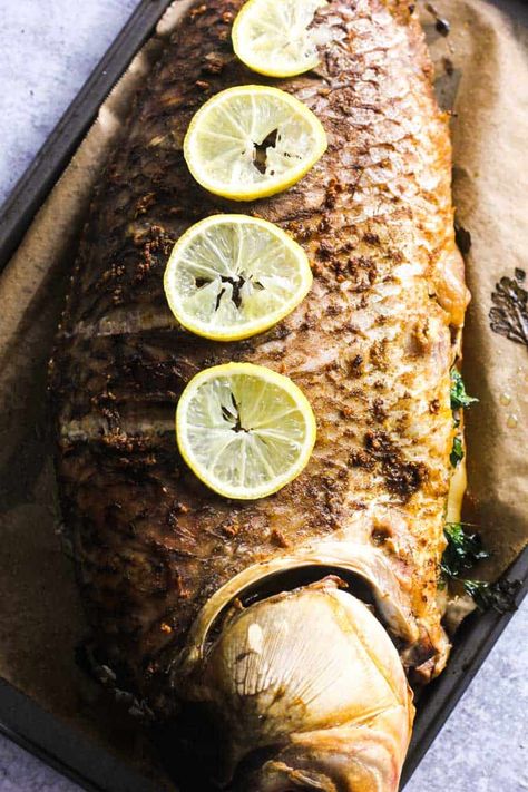 Baked buffalo fish is juicy and flaky with wonderfully crispy skin. Flavorful cajun-seasoned fish is stuffed with parsley and topped with a lemon garlic butter sauce. This simple whole buffalo fish recipe looks impressive and serves as a wonderful light and delicious main dish! Buffalo Fish Recipes, Cajun Baked Fish Recipes Oven, Lubys Baked White Fish, Whole Branzino Recipe Baked, Buffalo Fish, Fish With Potatoes Oven Baked, Whole Fish Recipes Branzino, Fresh Fish Recipes, Lemon Garlic Butter Sauce