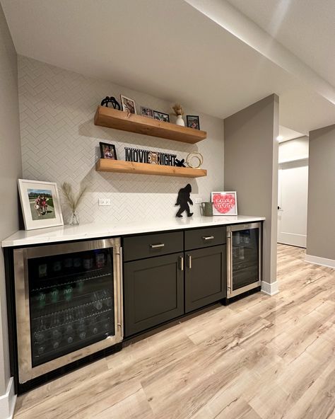 We just wrapped up another awesome basement transformation! 🎉 Here’s what we did: ✅ Entertainment & Flex Space Created a cozy spot for TV and a flexible area that can be used for anything you need. ✅ Home Gym Sprayed the ceiling black, added crown molding, and installed a TV in the corner. Double glass doors give it an open feel. ✅ Dry Bar Installed a sleek 8’ dry bar with cabinets and two beverage fridges. Finished it off with stylish shiplap. ✅ Wine Room Built a 4’ x 4’ wine room under ... Basement Tv And Bar Ideas, Built In Bar With Wine Fridge, Living Room With Bar Area, Black Basement Bar, Wet Bar Ideas With Sink, Basement Bar With Tv, Basement Snack Bar, Bar With Cabinets, Wet Bar In Basement