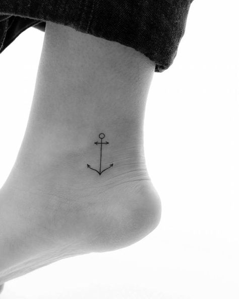 Anchor Minimalist anchor tattoo on an ankle, symbolizing stability and strength. Black ink fine-line tattoo design on the side of the foot. | Sky Rye Design Anchor Tattoo Fine Line, Fine Line Anchor Tattoo, Minimalist Anchor Tattoo, Anchor Tattoos For Women, Tiny Anchor Tattoo, Mountain Range Tattoo, Fine Line Tattoo Ideas, Small Wave Tattoo, Symmetrical Tattoo