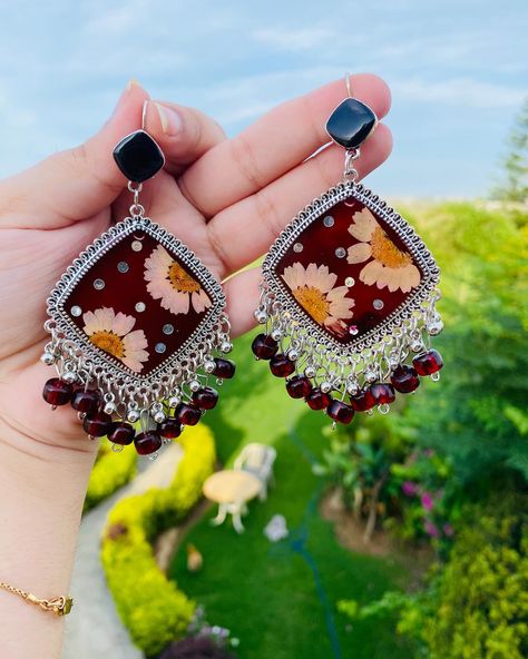 Dark Red Resin Jhumkas Customisation is also available Price: 3000/- Type: lightweight and easy to wear . . . #resinart #jewelry #earrings #rosé #petals #preservation #memories #memoriespreserved #jhumkas #necklace #ring #smallbusiness #hardwork #womenempowerment #workingwomen #rings #necklace #handcrafted #handmade #withlove #foryoupage #explore #reels #reelsinstagram #foryou #accessories Resin Jhumka Earrings, Resin Jhumka, Resin Jewelry Diy, Rings Necklace, Resin Tutorial, Necklace Ring, Jhumka Earrings, Handmade Jewellery, Resin Diy