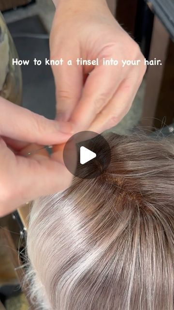 WhiteRock " Master Hairstylist" on Instagram: "“Add a touch of sparkle to your hair with this easy tinsel knot technique! ✨   Tinsel installation steps:  1.	Take one tinsel and fold it in half. 2.	Create a loop and pull one strand of hair through the loop. Use a very small strand of hair, maybe three single hairs. 3.	Make a knot between the hair and the tinsel. 4.	Take the two tinsel strands and do two double knots.  And that’s it!  “Please follow, like, save, and share if you love this look! Your support means the world to us. ❤️🙏”  #tinselhair #hairtutorial #hairhowto #whiterockhaircut #whiterockbchairstylist #hairsparkle #hairaccessories #funhair #hairfashion #hairstyles #stardustmagic #hairtinsels" Sparkle Strands In Hair, How To Do Tinsel In Hair, How To Tie Hair Tinsel In Hair, Hair Tinsel Slip Knot, Tinsels In Brown Hair, Braid Thread In Hair, How Do You Put Tinsel In Your Hair, How To Put Tensile In Your Hair, Braiding Tinsel Into Hair