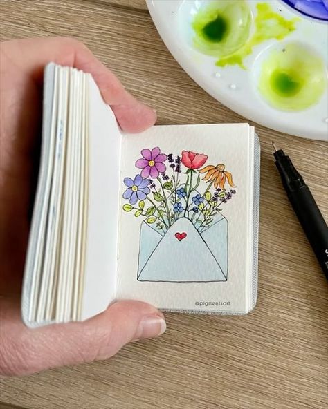 Pigments Art on Instagram: "For the love of flowers 🌷🌼🪻Swipe for photo 👉🏻  A simple ink drawing brought to life with watercolours. I’ve painted this in one of my Midi journals . Blank journals in various styles, colours and sizes are available on my website in a choice of genuine leather or faux leather covers. Link in my bio  . Pen: @stationery_island 0.5 fineliner Paint: Winsor and Newton Cotman  Brushes: @princetonbrush Journal: Pigments Art midi  . . . #travelsketchbook #artsupplies #artmaterials #artjournalsupplies #littleart #minipaintings #natureartwork #journals #journaling #pigmentsart #minijournal #artjournal #journallove #journalinspiration #journalinspo #journalart #journalcommunity #creativejournaling #handmadejournal #watercolorjournal #tinysketchbook #miniwatercolor #tr Pencil And Acrylic Art, Small Art Ideas Drawing, Pen On Watercolor, Drawing With Colour Pens, Simple Paint Pen Art, Coloured Pen Drawings, Coloured Pen Art, Watercolor Doodles Journaling, Mini Watercolor Painting