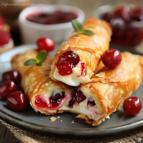 These Cherry Cheesecake Egg Rolls combine creamy cheesecake filling and sweet cherry pie filling, all wrapped in a crispy egg roll wrapper. An easy and delightful dessert. Cheesecake Rolls, Rolls Dessert, Recipe For Snacks, Home Made Sweets Easy, Desserts With Egg Roll Wrappers, Egg Roll Filling Ideas, Sweet Egg Rolls, Sweet Pastry, Strawberry Cheesecake Egg Rolls