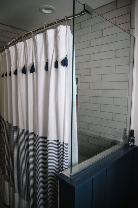 Newly renovated bath/shower with tempered glass wall.. Shower curtain by Peri Home, bloomingdales . 3x12 Retro Perla gray Tile via the Tile shop . Photo via Rachel Cuthbert Photography Adult Living Room Ideas, Gray Tile, Pony Wall, Cambria Quartz, Glass Curtain, Blue Shower Curtains, Pink Baths, Blue Cabinets, The Tile Shop